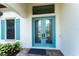 Elegant double front door with transom window and blue trim accents create a welcoming entrance at 148 Mossy River Ct, Brandon, FL 33511