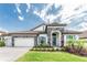 Charming single-story home showcasing a tiled roof, stone accents, and well-manicured front yard at 148 Mossy River Ct, Brandon, FL 33511