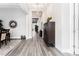 Long hallway featuring wood-look tile flooring, stylish furnishings, and modern lighting fixtures at 148 Mossy River Ct, Brandon, FL 33511