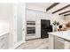 Bright kitchen with stainless appliances, double ovens, and wood-look tile flooring at 148 Mossy River Ct, Brandon, FL 33511