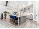 Open kitchen with a large island, pendant lights, stainless steel appliances, and gray cabinetry at 148 Mossy River Ct, Brandon, FL 33511