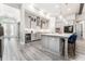 Open-concept kitchen features stainless steel appliances, gray cabinetry, and an island with seating at 148 Mossy River Ct, Brandon, FL 33511