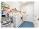 Bright laundry room with modern washer, dryer, shelving, and storage at 148 Mossy River Ct, Brandon, FL 33511