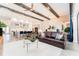 Spacious living room features wood beam ceilings, open concept kitchen, and plush furnishings at 148 Mossy River Ct, Brandon, FL 33511