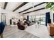 Beautiful living room featuring dark wood ceiling beams and a sliding glass door to the pool at 148 Mossy River Ct, Brandon, FL 33511