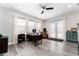 Light and bright office space featuring wood look floors, multiple windows, and neutral paint at 148 Mossy River Ct, Brandon, FL 33511