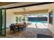 Outdoor patio with a ceiling fan, a table with chairs, and a view of the screened-in pool at 148 Mossy River Ct, Brandon, FL 33511
