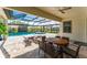 Comfortable covered patio featuring a dining area with view of the pool at 148 Mossy River Ct, Brandon, FL 33511