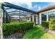 Landscaped backyard with a screened-in pool area adding privacy and beauty at 148 Mossy River Ct, Brandon, FL 33511