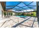 Relaxing screened-in pool and spa with an extended brick-paved patio and lush landscaping at 148 Mossy River Ct, Brandon, FL 33511