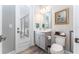 Stylish powder room with gray vanity, modern fixtures, and a door to the outside at 148 Mossy River Ct, Brandon, FL 33511
