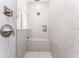 Modern shower with gray tiling, a built-in bench, and sleek fixtures at 148 Mossy River Ct, Brandon, FL 33511