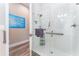 Walk-in shower with white tile, a glass enclosure, and chrome fixtures at 148 Mossy River Ct, Brandon, FL 33511