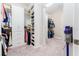 Walk-in closet with custom shelving, storage, and carpeted floors at 148 Mossy River Ct, Brandon, FL 33511
