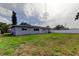 Backyard featuring a lush lawn, partial fence, and mature trees at 1516 Lemon St, Clearwater, FL 33756