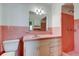 Retro pink bathroom with tile, sink, vanity, toilet, and shower at 1516 Lemon St, Clearwater, FL 33756