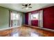 Bright bedroom with wood look tile flooring, ceiling fan, and two windows at 1516 Lemon St, Clearwater, FL 33756