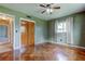 Bedroom with wood look tile flooring, ceiling fan, window and closet at 1516 Lemon St, Clearwater, FL 33756