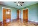 Bedroom featuring wood look tile floors, ceiling fan and large closet at 1516 Lemon St, Clearwater, FL 33756