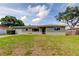 Charming single-story home features a well-maintained lawn and attached garage at 1516 Lemon St, Clearwater, FL 33756
