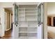 Hallway featuring open decorative cabinet doors, providing ample storage space at 1516 Lemon St, Clearwater, FL 33756