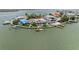 Aerial view of waterfront home with a private dock, lush landscaping, and beautiful water views of the cove at 17382 Kennedy Dr, North Redington Beach, FL 33708