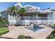 Backyard featuring a relaxing spa with a decorative water feature with palm trees and waterfront views at 17382 Kennedy Dr, North Redington Beach, FL 33708