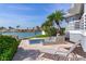 Backyard featuring a luxurious outdoor area with a water feature, waterfront views, and lounge chair for relaxation at 17382 Kennedy Dr, North Redington Beach, FL 33708