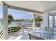 Covered balcony with views of canal, seating, and tropical foliage, perfect for relaxing and enjoying waterfront scenery at 17382 Kennedy Dr, North Redington Beach, FL 33708