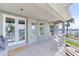 Spacious covered balcony with water view, accessible through french doors, a relaxing and functional outdoor space at 17382 Kennedy Dr, North Redington Beach, FL 33708