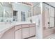 Well-lit bathroom featuring sleek vanity, large mirror, and glass-enclosed shower, offering a modern and clean aesthetic at 17382 Kennedy Dr, North Redington Beach, FL 33708