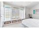 Bright bedroom features large windows with a built-in bench, offering natural light and extra storage at 17382 Kennedy Dr, North Redington Beach, FL 33708