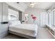 Bright bedroom with white walls, a built-in wardrobe, and view to the bathroom provides a cozy and airy feel at 17382 Kennedy Dr, North Redington Beach, FL 33708