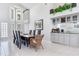 Bright dining room with high ceilings, modern lighting, and adjacent bar area at 17382 Kennedy Dr, North Redington Beach, FL 33708