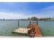 Private dock with boat lift on a calm canal, providing easy access to waterfront activities and beautiful views at 17382 Kennedy Dr, North Redington Beach, FL 33708