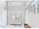 Entrance featuring tile flooring, double doors with glass inserts, and decorative glass block accents at 17382 Kennedy Dr, North Redington Beach, FL 33708