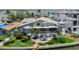 Beautiful home featuring lush landscaping, a water feature, a patio, and a stunning exterior elevation with waterfront views at 17382 Kennedy Dr, North Redington Beach, FL 33708