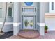 Front entrance to home featuring double doors, brick walkway, and prominent address display at 17382 Kennedy Dr, North Redington Beach, FL 33708