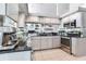 Modern kitchen features stainless appliances, ample cabinet space, and reflective backsplash at 17382 Kennedy Dr, North Redington Beach, FL 33708