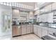 Well-lit kitchen with granite counters, stainless steel appliances, and water view at 17382 Kennedy Dr, North Redington Beach, FL 33708
