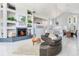 Open floor plan with a fireplace, stairs, and casual dining area at 17382 Kennedy Dr, North Redington Beach, FL 33708