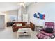 Cozy living room features a comfy sofa, accent chair, and view of the office space and bathroom at 17382 Kennedy Dr, North Redington Beach, FL 33708