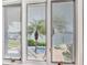 Window view featuring a pool, canal, and palm trees at 17382 Kennedy Dr, North Redington Beach, FL 33708