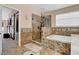A luxurious bathroom showcasing a glass enclosed shower and separate soaking tub with natural light from a window at 1751 Split Fork Dr, Oldsmar, FL 34677