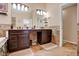 Primary bathroom featuring dual sinks, travertine tile, and modern fixtures at 1751 Split Fork Dr, Oldsmar, FL 34677