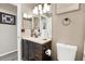 Updated bathroom with a dark wood vanity cabinet, modern lighting, and neutral walls at 1751 Split Fork Dr, Oldsmar, FL 34677