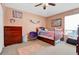 Cozy bedroom with colorful decor, ceiling fan, and a plush rug on the carpet at 1751 Split Fork Dr, Oldsmar, FL 34677