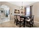 Elegant dining room with stylish table and chairs, decorative lighting, and adjacent kitchen area at 1751 Split Fork Dr, Oldsmar, FL 34677