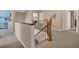 Hallway featuring neutral walls, staircase, and a view to a room with an ironing board at 1751 Split Fork Dr, Oldsmar, FL 34677