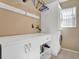 Bright laundry room with white cabinets, plenty of counter space, and a stacked washer/dryer at 1751 Split Fork Dr, Oldsmar, FL 34677
